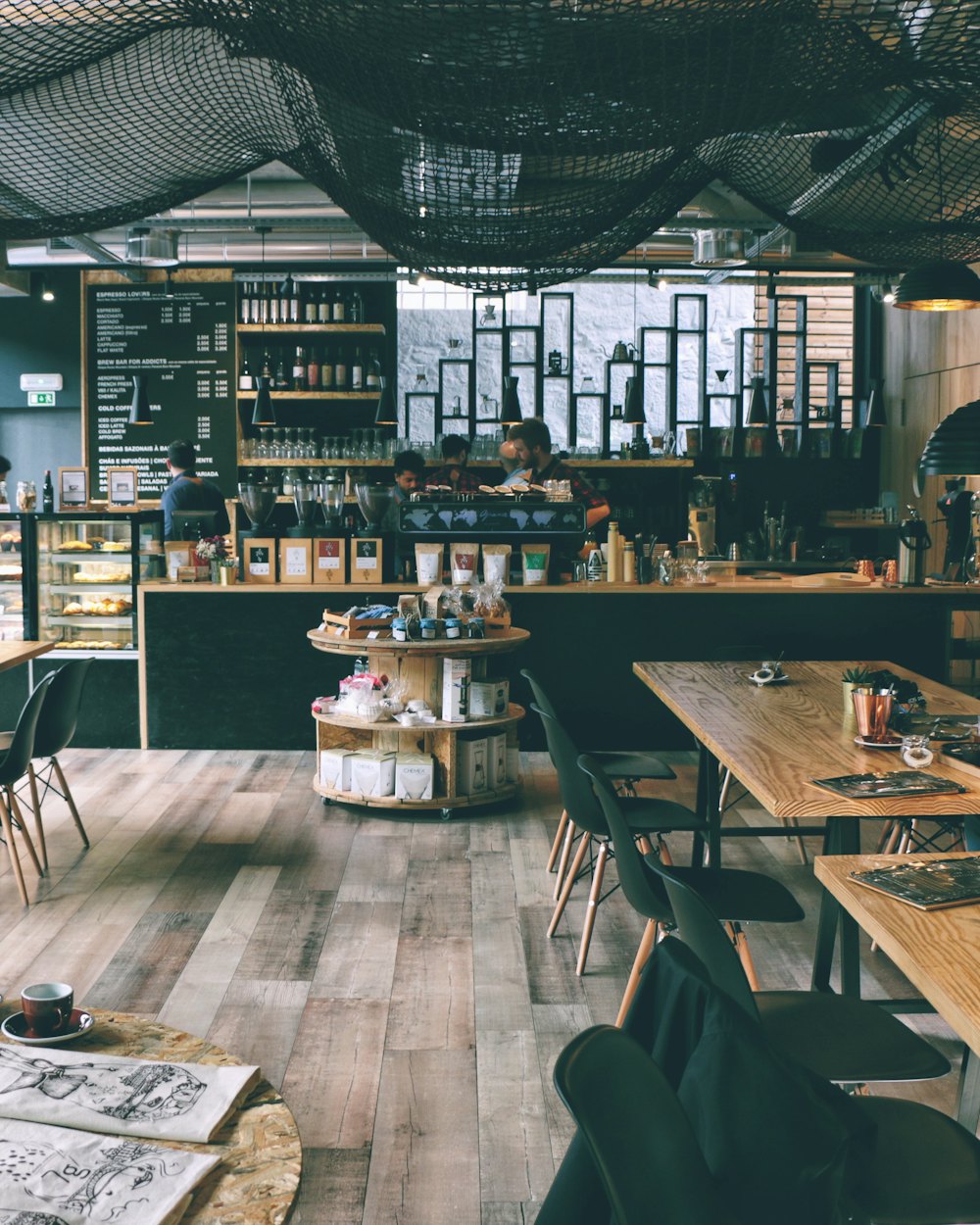 The main room with its long timber table and shelves of coffee gear