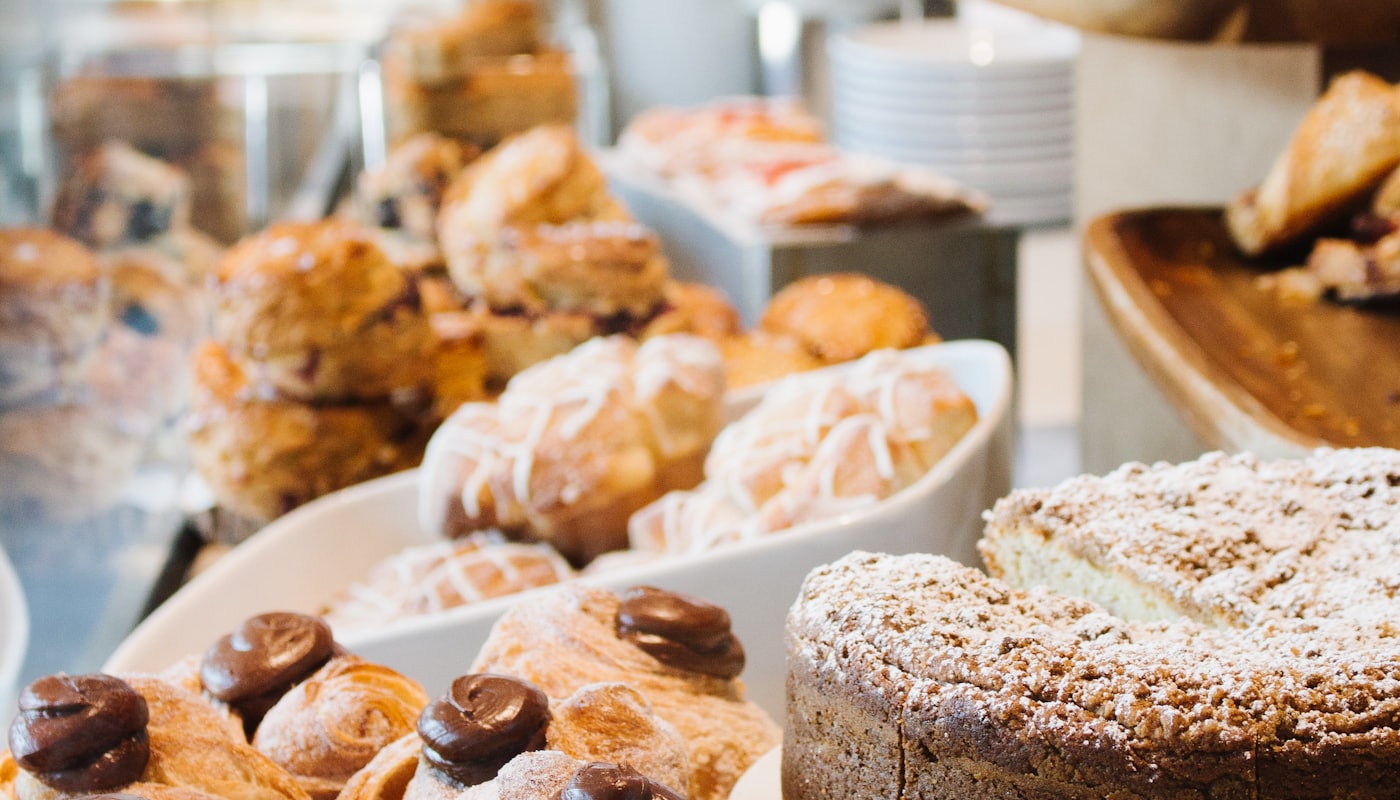 Chocolate-topped pastries and crumb cake in the counter display