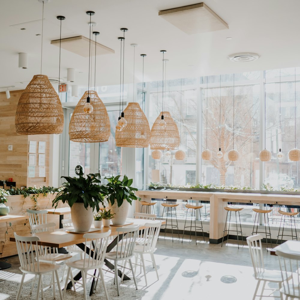 Bright window-side seating under woven rattan pendant lamps