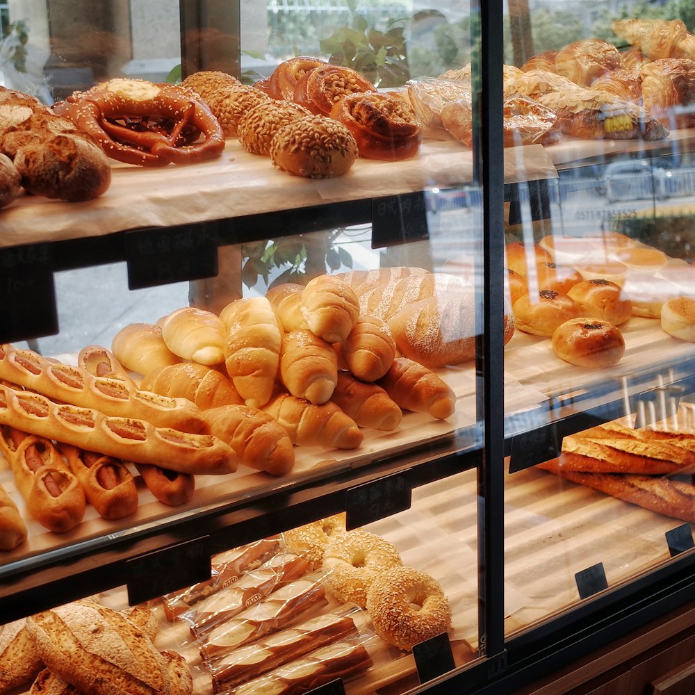 Loaves and pastries lined up along the bakery display shelf