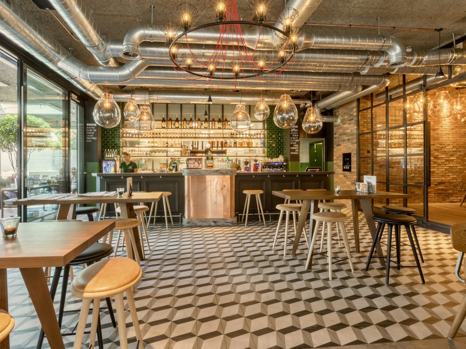 The café room in warm timber with counter stools and a chequered floor