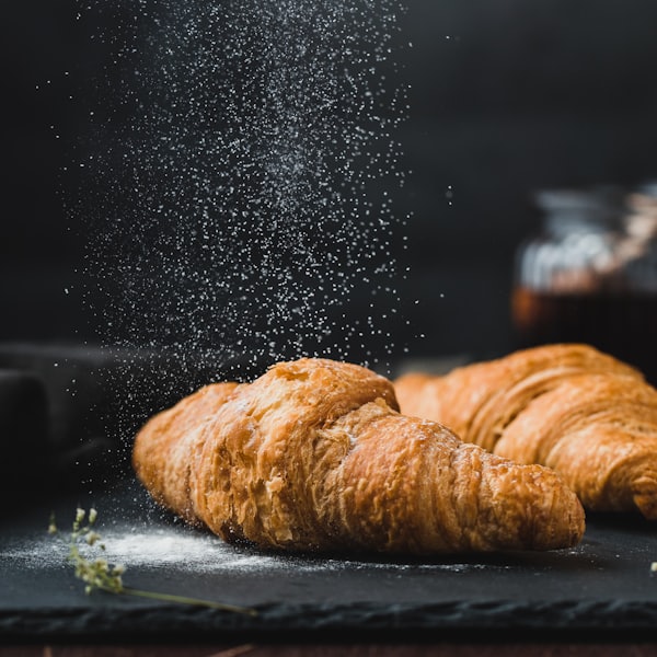 Two golden croissants fresh from the oven