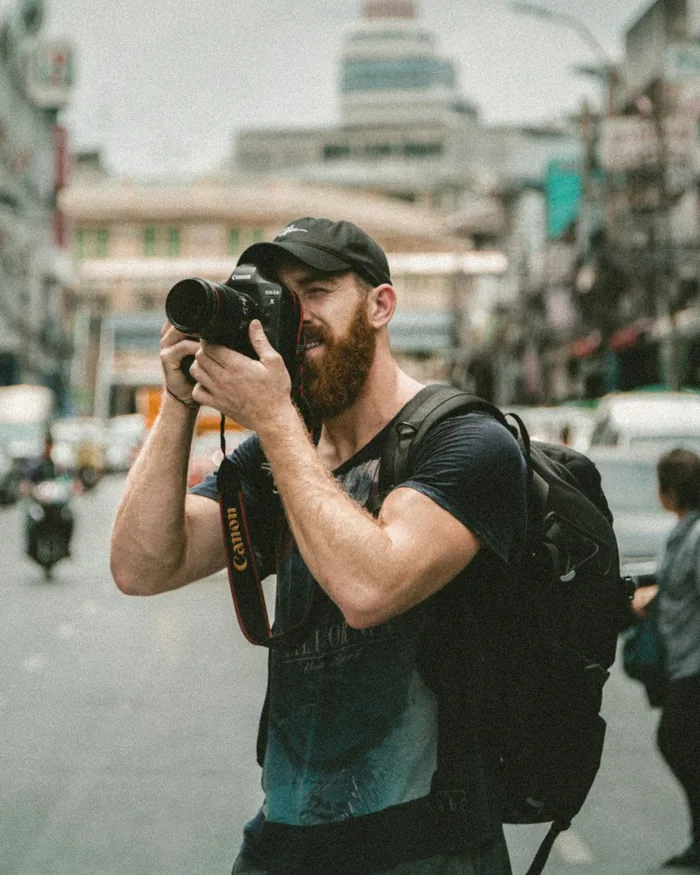 Photographer shooting handheld on a busy street