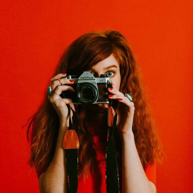 Portrait of the studio founder holding a film camera