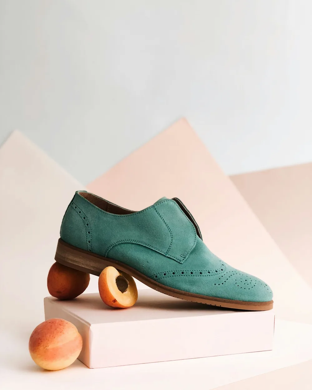 Green leather brogue styled on a sculptural pedestal
