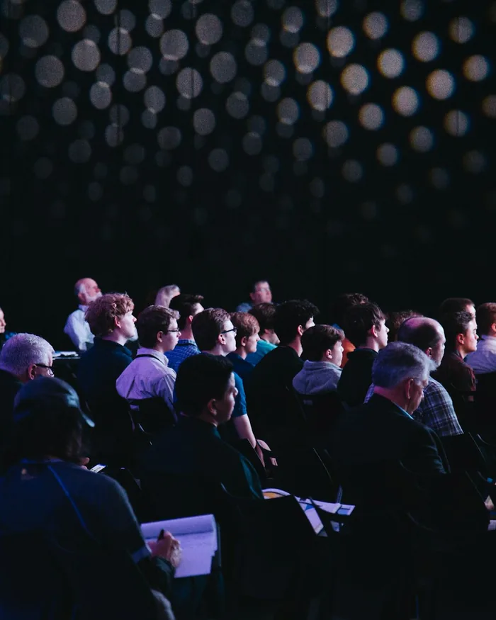 Audience silhouetted in a darkened auditorium