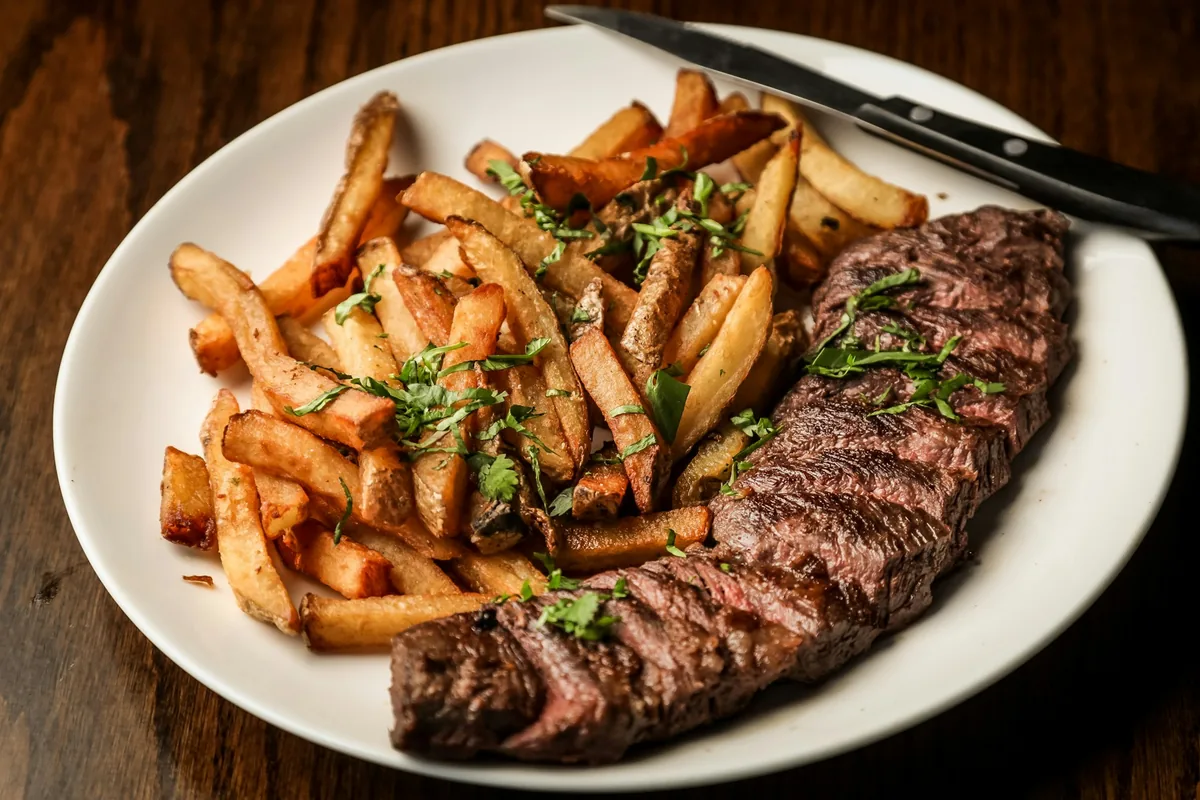 Steak and fries plated for a restaurant campaign