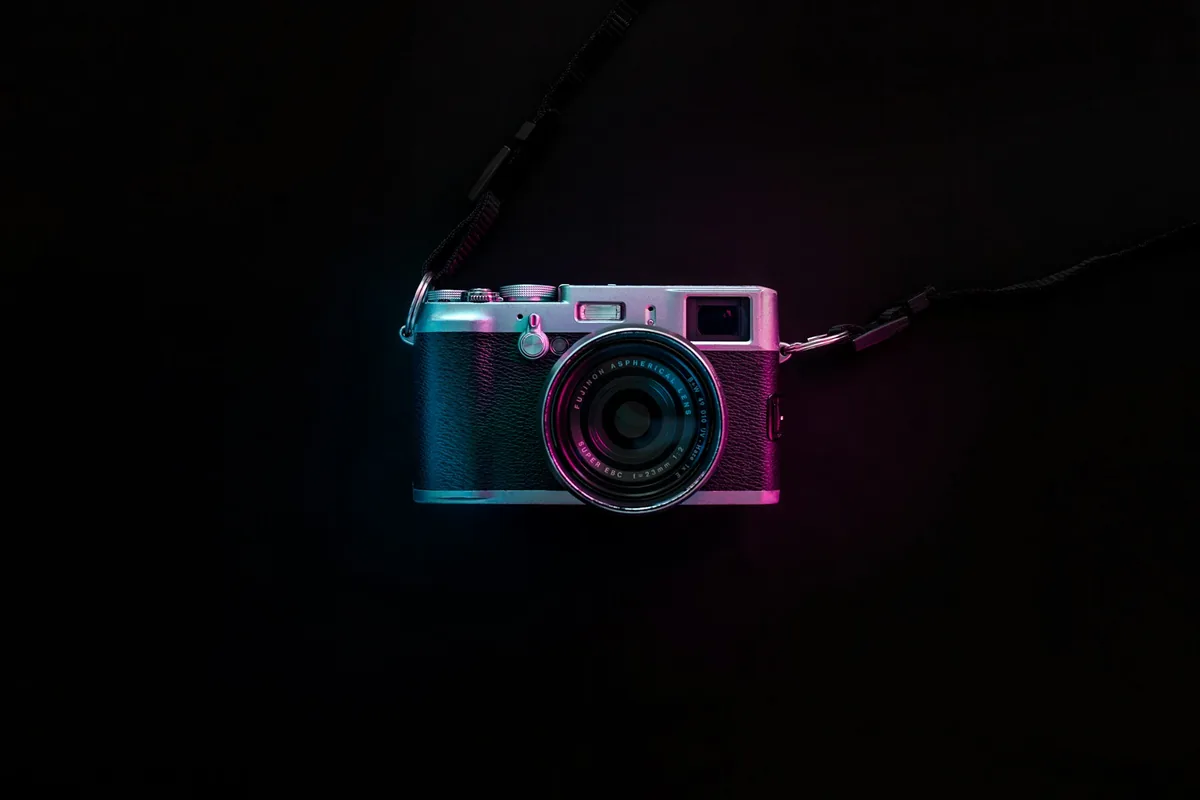 Camera outlined in pink and blue neon light