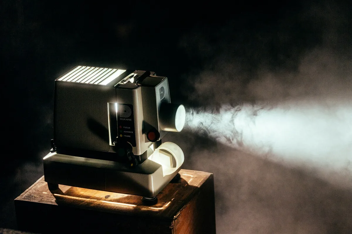 Vintage projector throwing a beam through haze