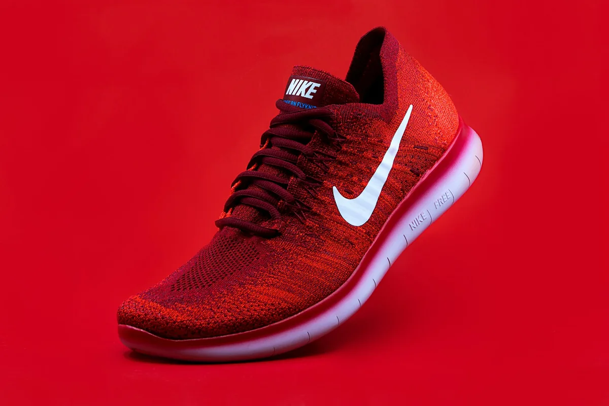 Red running shoe on a bold red background