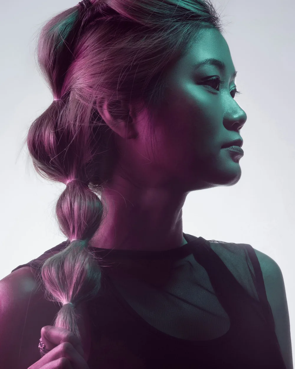 Profile portrait lit with magenta and green gels