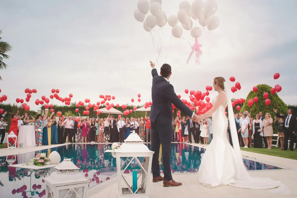 Couple releasing balloons at their wedding reception