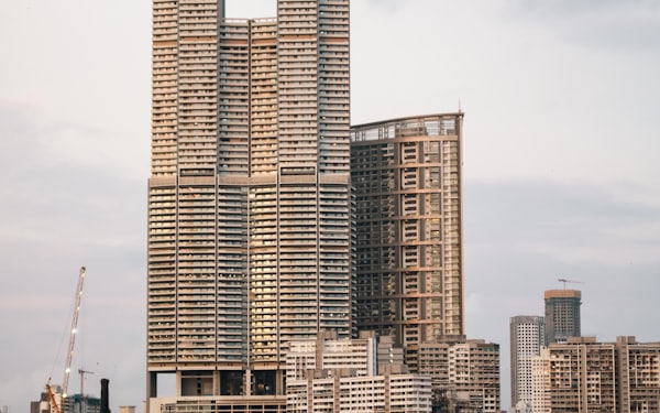 A cluster of tall apartment towers in the foreground of a city skyline