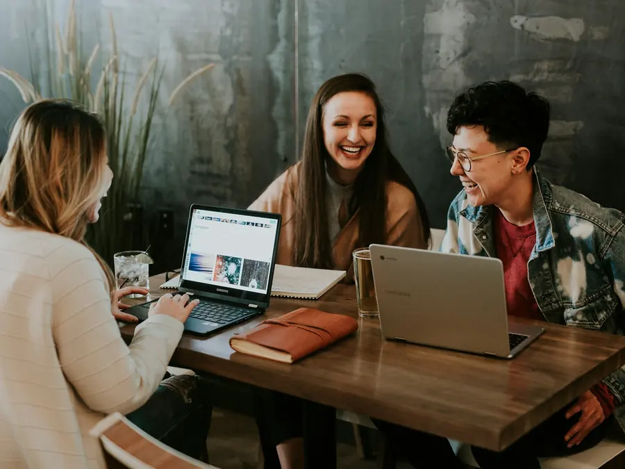 Travel consultants planning itineraries together at a desk