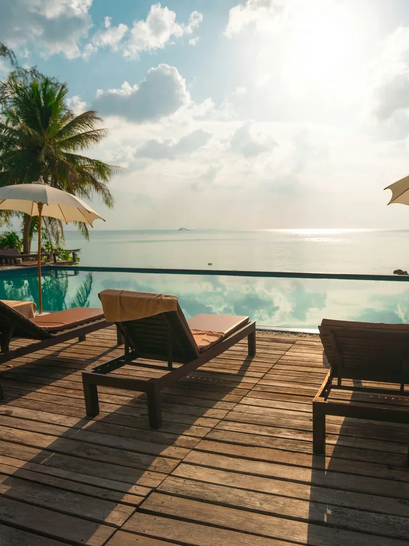 Sun loungers and umbrellas on a resort deck by the sea