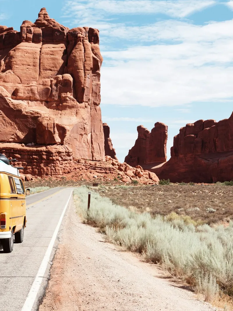 Camper van parked on a desert road on a weekend trip