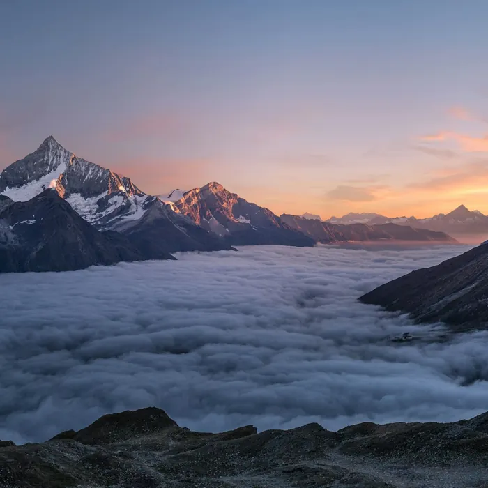 Mountain peak above a sea of cloud at golden hour