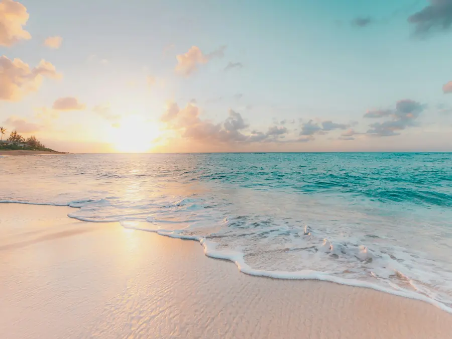 Quiet beach at sunset with soft reflections